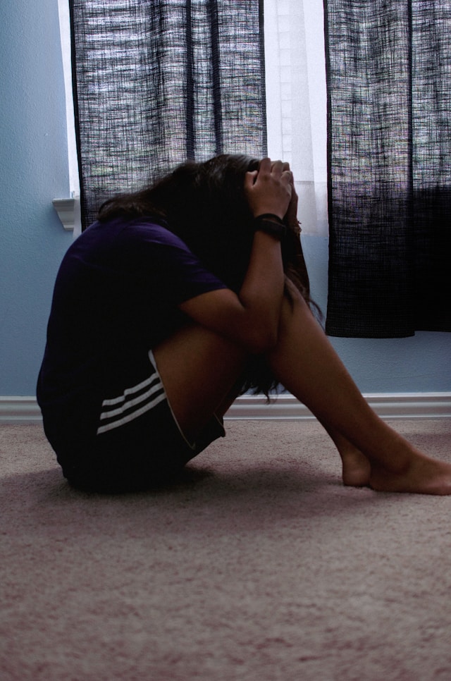 depressed girl covering head